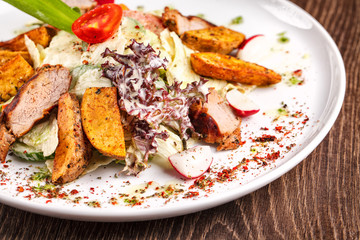 salad with fresh vegetables grilled veal and baked potatoes