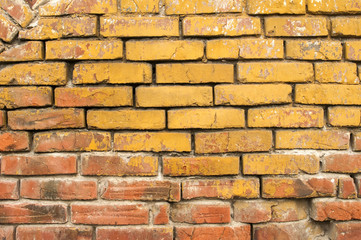 Old grunge weathered vintage crumbling brick wall closeup as background