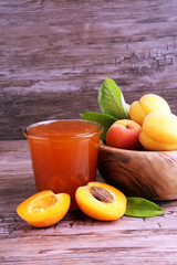 Apricot jam in glass bowl with fruit around