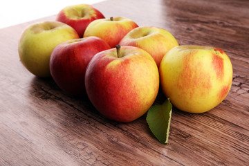 Ripe red apples on wooden background summer concept
