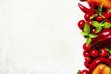 Red peppers, tomatoes and chili, food background, top view