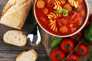 Tomato soup with meatballs in a bowl. Italian minestrone soup