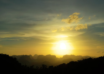 Low key image of sunset over the mountains. Krabi, Thailand.