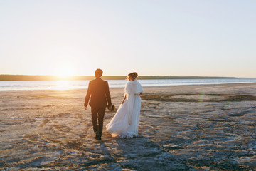 Groom and bride on a walk outdoors at the sea