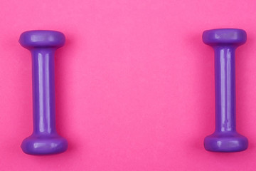 Purple dumbbells on a pink background