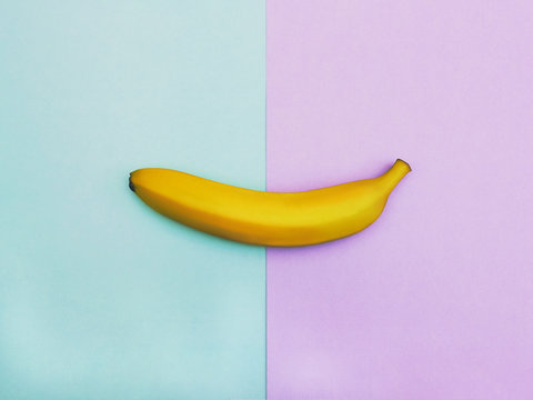 Flat lay fruit Top view trendy photo Ripe yellow banana is lying on two-tone background Colorful flat lay photo of banana fruit with space for text