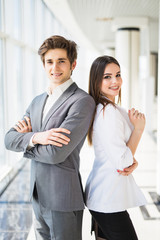 Confident business team of man and woman standing with crossed hands, team spirit concept, couple of success business people ready to act, business manager and employee,ready to implement plans