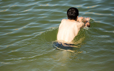 The man is swimming in the lake