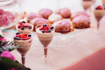 Glasses with desserts of chocolate cream and berries