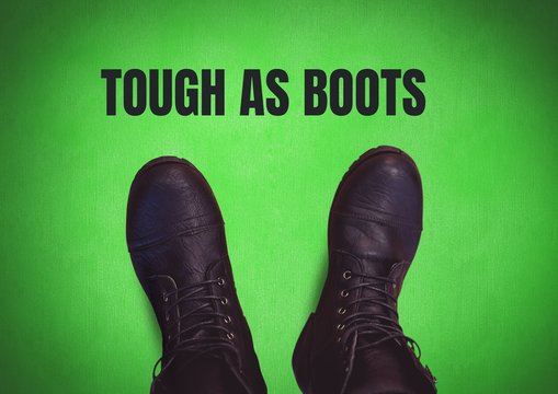 Tough as boots text and Black shoes on feet with green backgroun