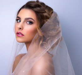 beautiful woman  bride with tiara on head  on bright background , copy space.