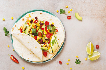 Vegetarian taco wraps. Vegetable tacos with ingredients on rustic surface. Top view, blank space © happyimages