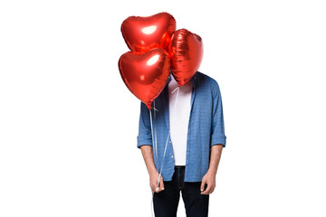 man with heart shaped balloons