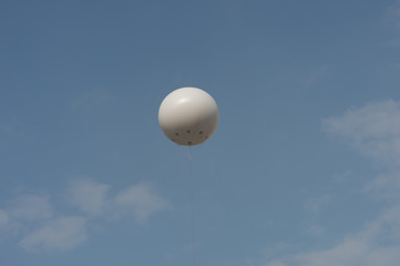 White balloons in the sky.