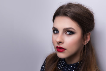 Fototapeta premium Fashionable portrait of a girl model with red lips.