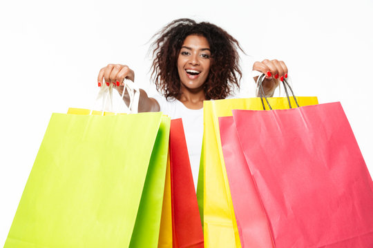 Happy Young African Woman Holding Shopping Bags.