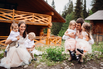 Mother and father hold their twins on the arms
