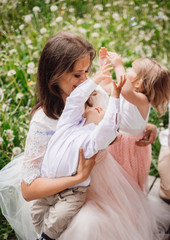 Obraz premium Mother hugs her pretty little children