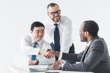 multiethnic businessmen shaking hands