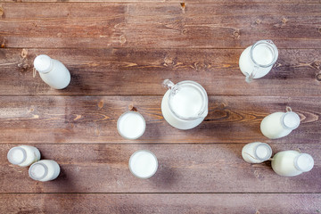 Obraz na płótnie Canvas milk and glasses of milk on a wooden rustic table. top view