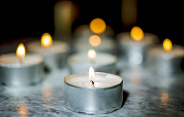 Tea candle, burning, solemn