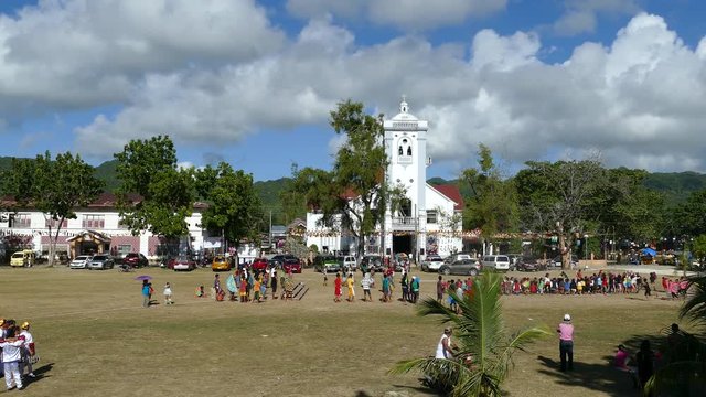 Kids practicing for the santo nino parade at Anda Municipal Plaza in Anda Bohol Island the Philippines 