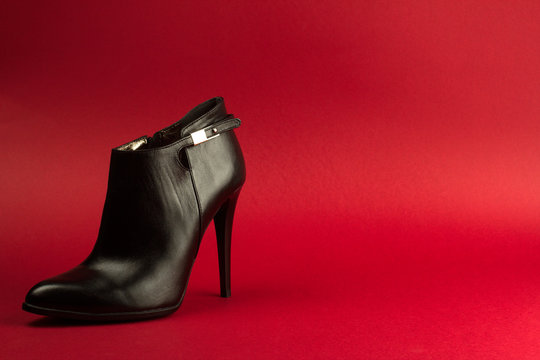 High Heel Black Shoe On Red Background