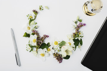 Spring flowers lined in the form of a crescent with a notepad an