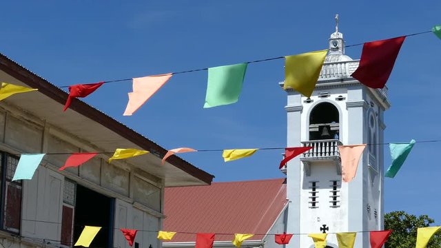 Flags in front of the Santo Nino de Anda Parish Church in anda bohol the Philippines
