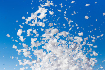 White foam against the blue sky as background