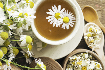 cup of herbal chamomile tea with camomile dry blossoms, dried camomile flowers. doctor treatment and prevention of immune concept, medicine - folk, alternative, complementary, traditional medicine 