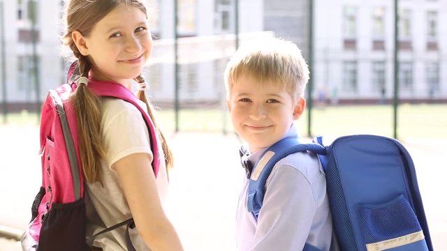  Portraits of children in the background of the school. Funny children. Sister and brother.