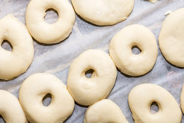 Flat lay above raw homemade domestic donuts dough ready for frying