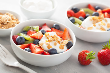 fruit berry salad with yogurt and granola for healthy breakfast