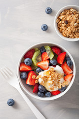 fruit berry salad with yogurt and granola for healthy breakfast