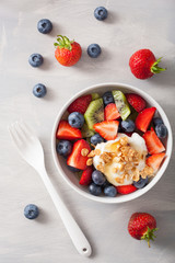 fruit berry salad with yogurt and granola for healthy breakfast