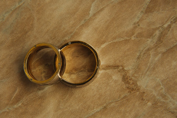Gold wedding rings for her and his. Wedding symbol. Selective focus