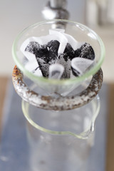 Separating by filtration the component substances from liquid mixture in Lab.