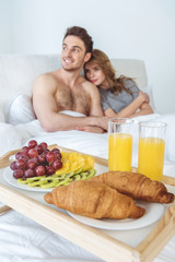 Obraz na płótnie Canvas couple with breakfast in bed