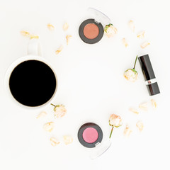 Coffee cup with petals with flowers and cosmetics on white background. Flat lay, top view.