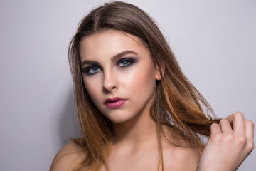 Fototapeta premium Fashionable portrait of a girl model. Fashion, smoky eyes makeup.