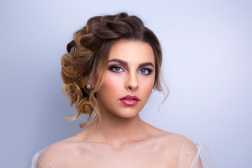 beautiful woman  bride with tiara on head  on bright background , copy space.