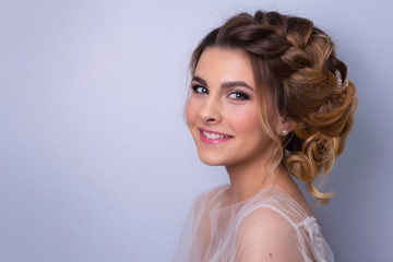 beautiful woman  bride with tiara on head  on bright background , copy space.