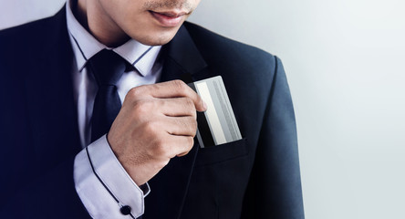 Businessman pulling Credit Card from his Pocket, Focus on hand and face