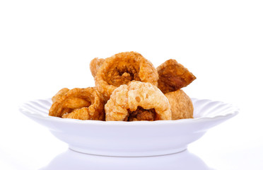 pork scratching in a plate on a white background