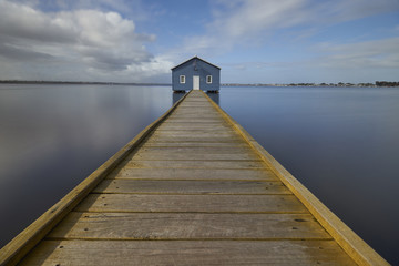 Boat shed with calm water wooden jetty