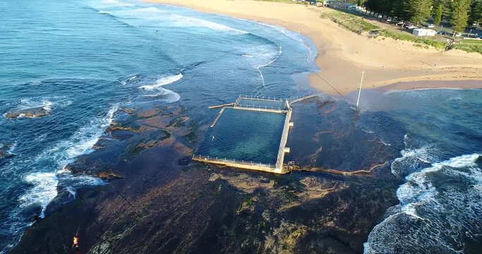 Rock pool at the tip of rocky plato off Mona Vale Northern beaches in Sydney &ndash; flying inland.