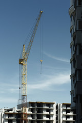 Fototapeta premium Building crane near a multi-storey building