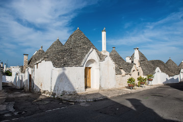 Fototapeta na wymiar a row of whote trulli house in Alberobello, Italy