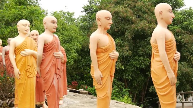 Pan from a group walking buddhas